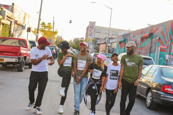 Group of people laughing together while walking