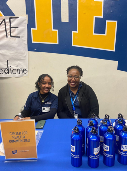 Two individuals tabling at an event promoting the CHC