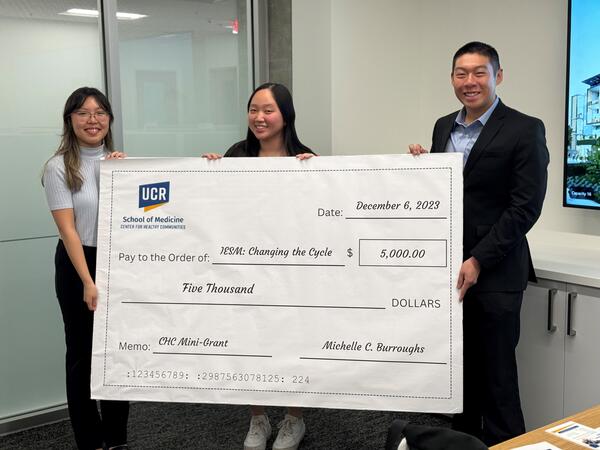 Inland Empire Street Medicine team holding giant $5,000 check