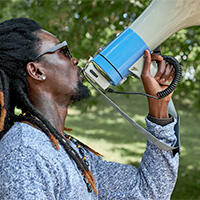 Black man speaking into a megaphone