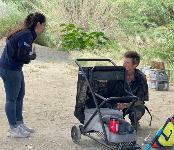 CHC worker engaging unsheltered individual at Santa Ana River Bottom