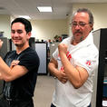 man_talk young and older man flexing biceps